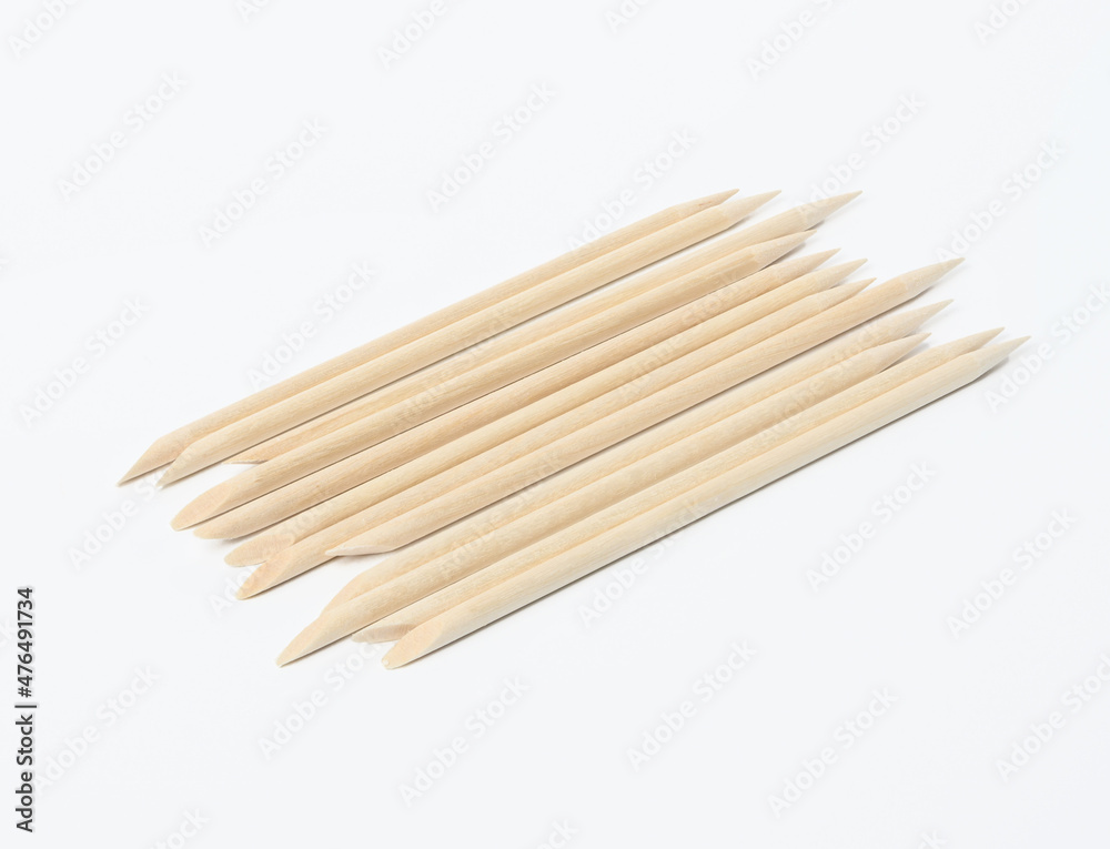 set of orange wooden manicure sticks on white background set of orange wooden manicure sticks on white background