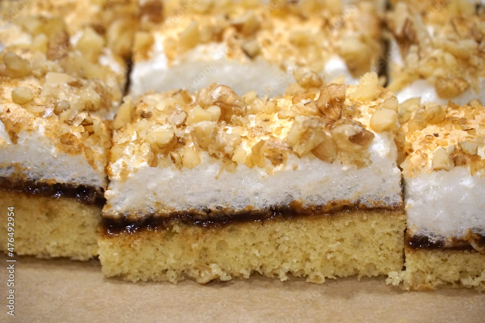 Layered biscuit cake with egg white snow and chopped nuts Layered biscuit cake with egg white snow and chopped nuts