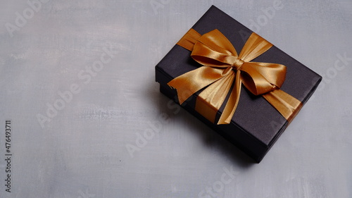 Cute gift box with satin ribbon on the table. Christmas and new year concept, Valentine Concept. Copy space, Negative Space. High View.