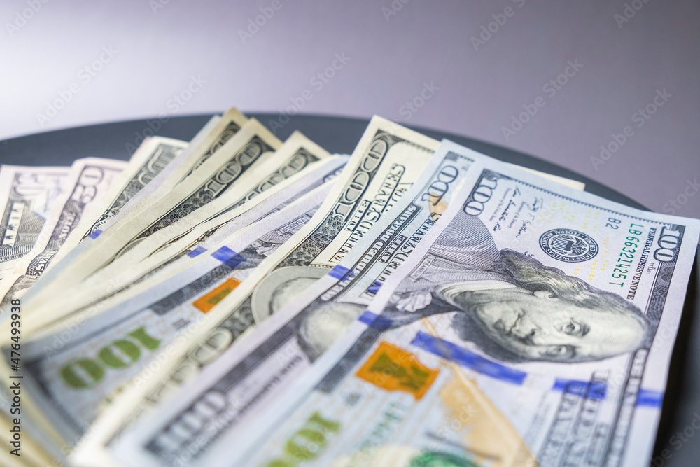 US Dollars bills on the gray plate US Dollars bills on the gray plate