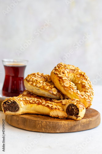 Turkish Ay coregi and tea. moon cookie on white background. Croissant with chocolate cocoa and raisin. Close up. Selective focus. Vertical view. Story format
