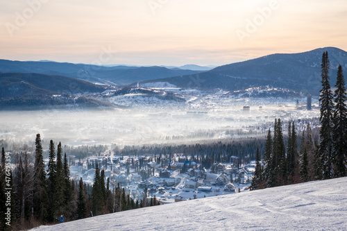 Winter landscape in Sheregesh ski resort in Russia, located in Mountain Shoriya, Siberia. Ski slopes and a view of the Sheregesh village photo