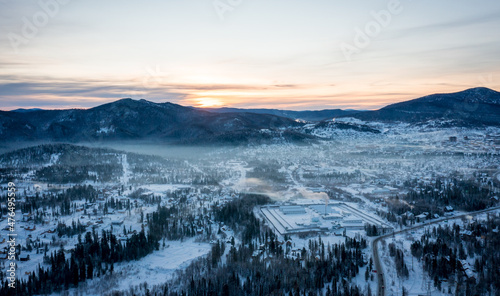 Winter landscape in Sheregesh ski resort in Russia, located in Mountain Shoriya, Siberia. Frosty morning in Siberia. Morning fog over the forest