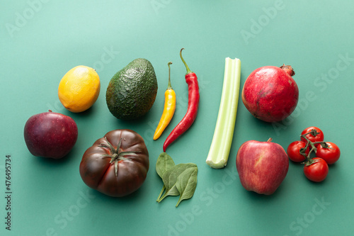 various fruits and vegetables on green background