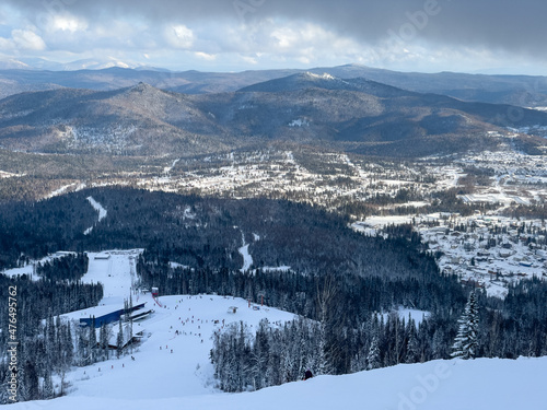 Winter landscape in Sheregesh ski resort in Russia, located in Mountain Shoriya, Siberia. Ski slopes and a view of the Sheregesh village