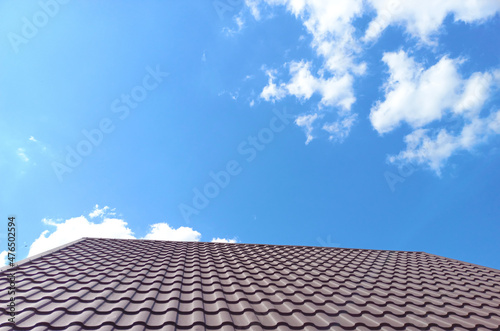 A metal tile roof against a blue sky