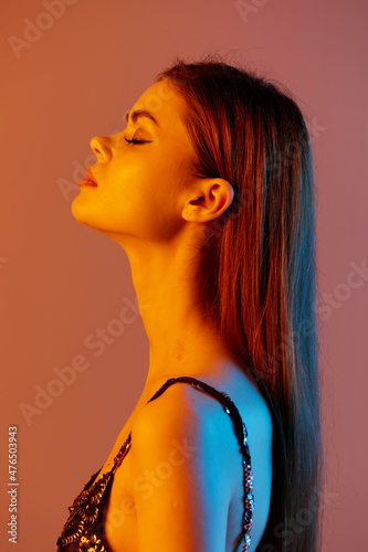 beautiful woman fashion posing shiny dress makeup color background