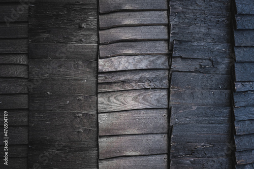 Obraz na płótnie Black burnt wooden texture background. Beautiful, stylish boards pattern with optical illusion of movement and ombre effect. Igloo sauna or house exterior design. Harsh wood without finish. Copy space w salonie