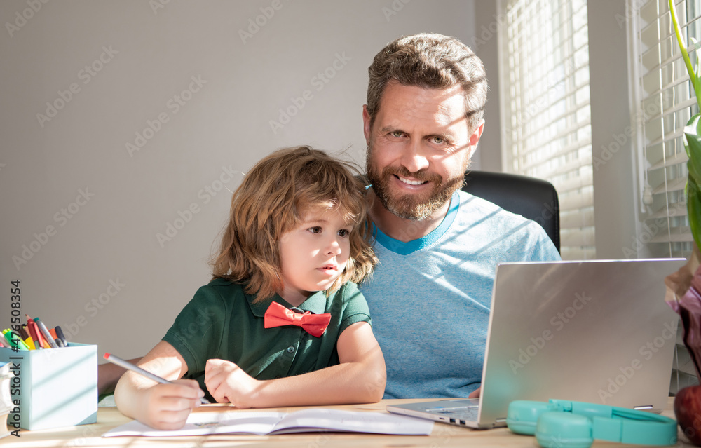 bearded dad or school private tutor teaching boy son with modern laptop, homeschooling