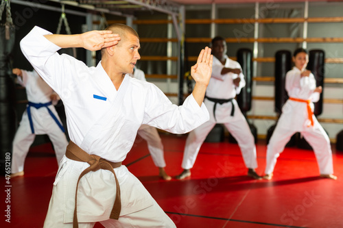 Man in kimono fighting stance at karate training