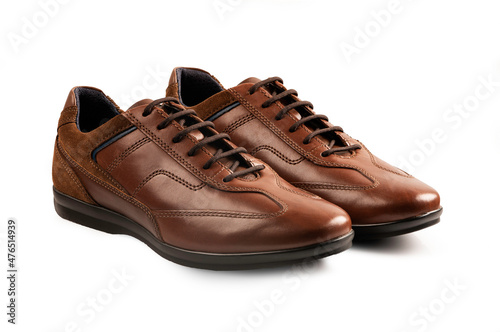 Pair of brown leather shoes on white background.