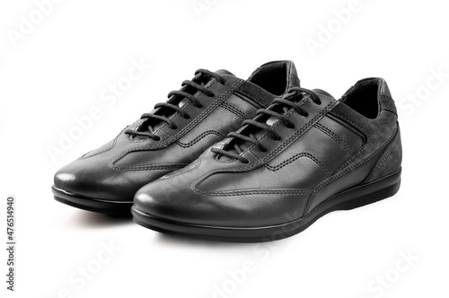 Pair of black leather shoes on white background.