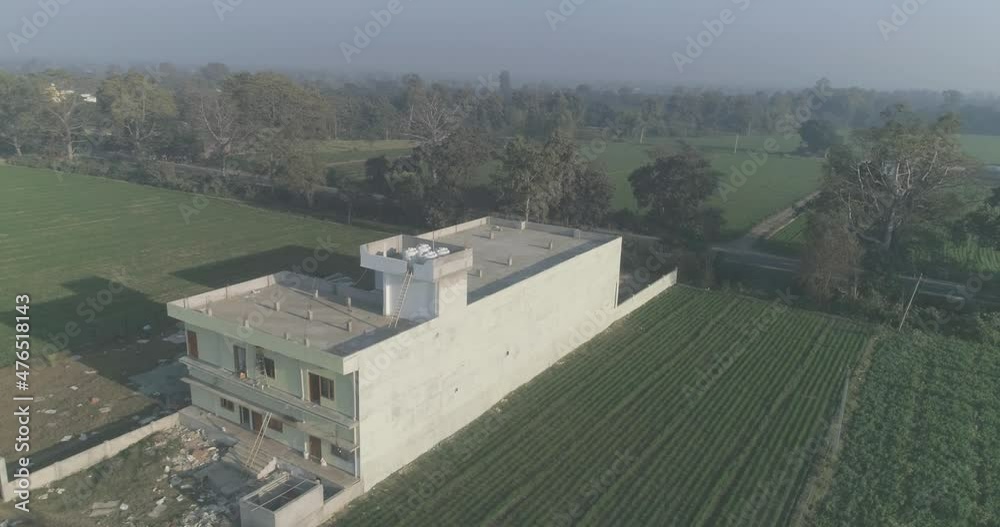 A new building is under construction just alongside a road in a rural tourist town in India A new building is under construction just alongside a road in a rural tourist town in India