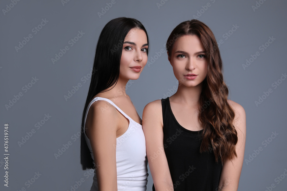 Portrait of beautiful women on grey background, space for text Portrait of beautiful women on grey background, space for text