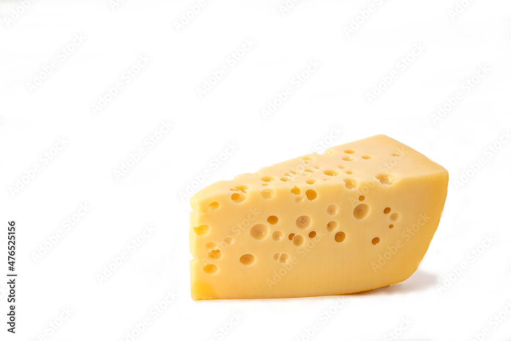 isolate with cheese. piece of emmental cheese on a white plate. a piece of cheese with holes on a white table