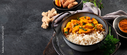 Fototapeta Naklejka Na Ścianę i Meble -  Indian butter chicken curry with basmati rice on dark background.