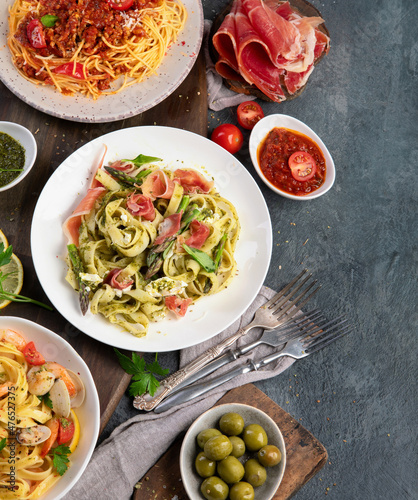 Pasta assortment on dark background. photo