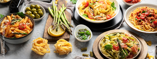 Pasta assortment on gray background.