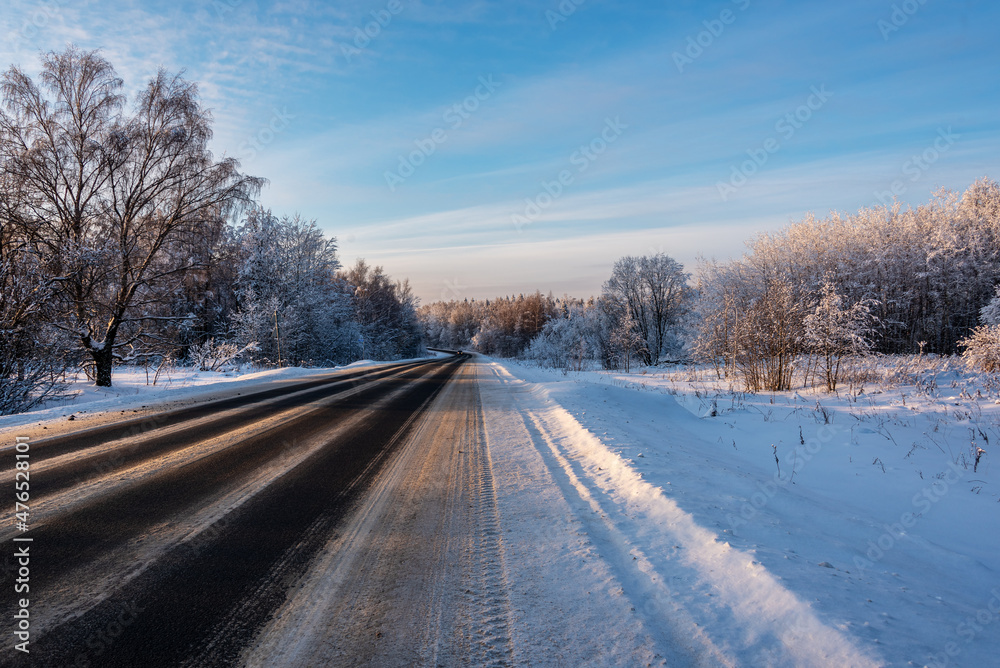 Country road among the winter forest covered with white snow. Country road among the winter forest covered with white snow.
