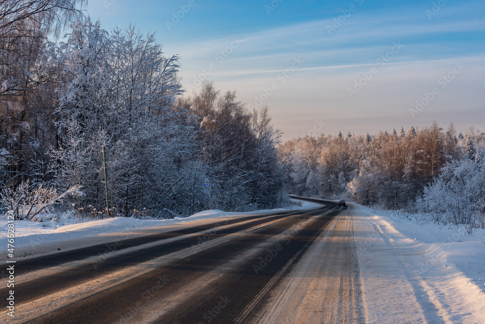 Country road among the winter forest covered with white snow. Country road among the winter forest covered with white snow.