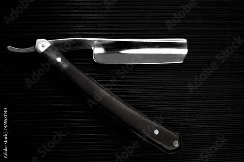 barber tool straight razor close in retro vintage style. Black and white picture