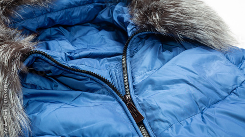 women winter fashion concept. blue jacket. down jacket with a hood. Winter outerwear for women on white background.
