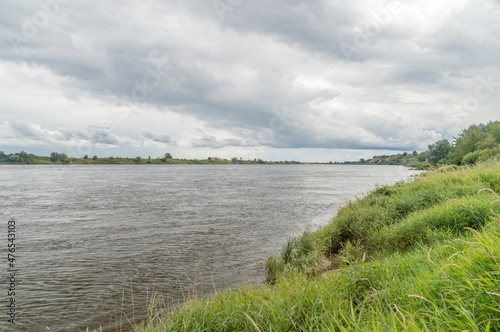 Landscape view on Vistula river near Knybawski bridge at cloudy day.