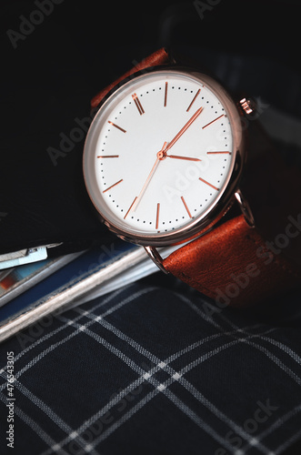 Men's watch side view with wallet. Stock photo.