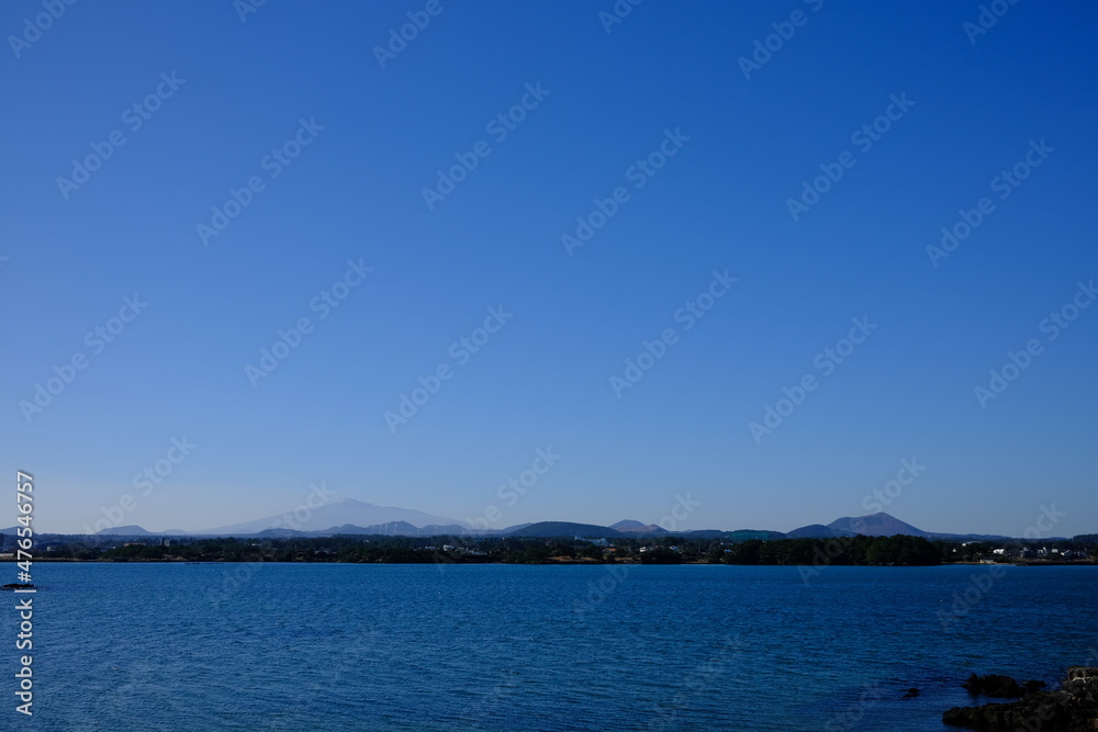 Blue sea and sky scenery of Seongsan Ilchulbong (UNESCO World Heritage Site) in Jeju Island, South Korea