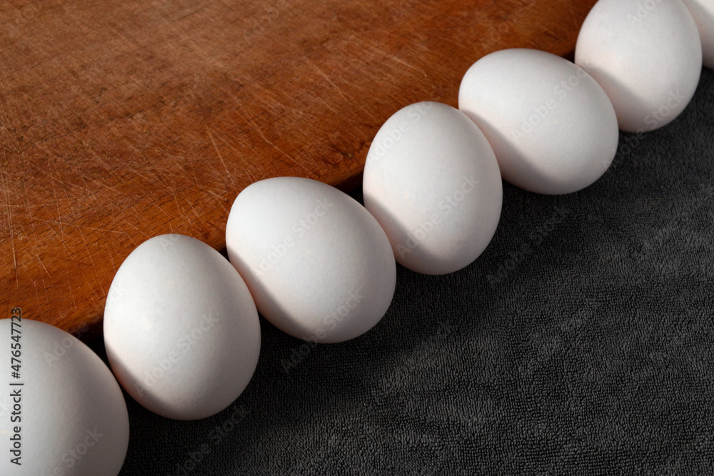 raw beautiful chicken eggs on wooden board raw beautiful chicken eggs on wooden board