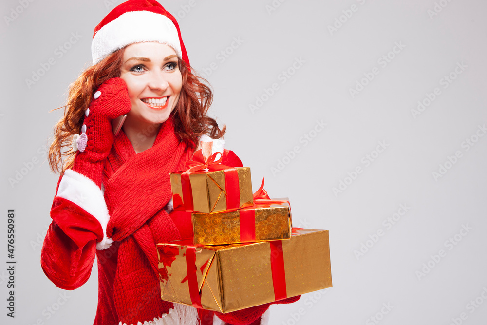 Christmas and New Year Concepts. Smiling Happy Snow Maiden with Lots of Beautifully Packed Christmas Presents Talking on Cellphone Against White. Christmas and New Year Concepts. Smiling Happy Snow Maiden with Lots of Beautifully Packed Christmas Presents Talking on Cellphone Against White.