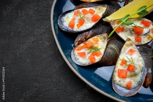 Baked mussels with cheese, salmon, lemon and herbs