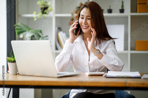 Start up small business entrepreneur SME or freelance asian woman using laptop with box, Young woman seller prepare parcel box of product for deliver to customer Online selling e-commerce SME concept.