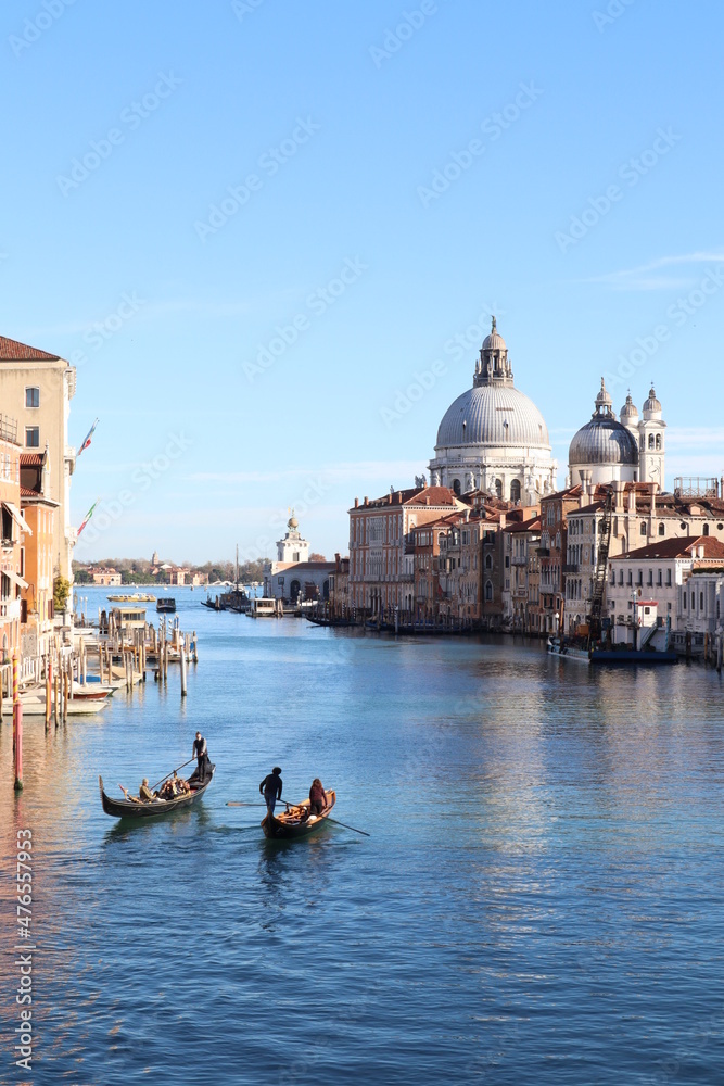 Beautiful view of Grand Canal with Venetian gondolas on a sunny day in Venice, Italy