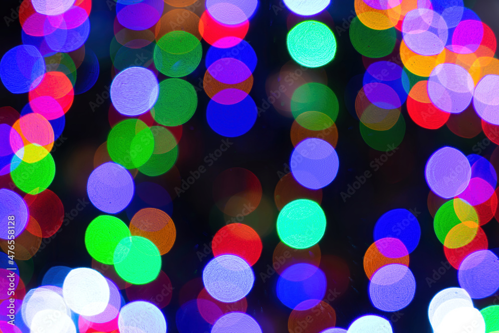 Abstract bokeh lights with soft light background. Festive abstract christmas texture, golden bokeh particles and highlights on dark background.