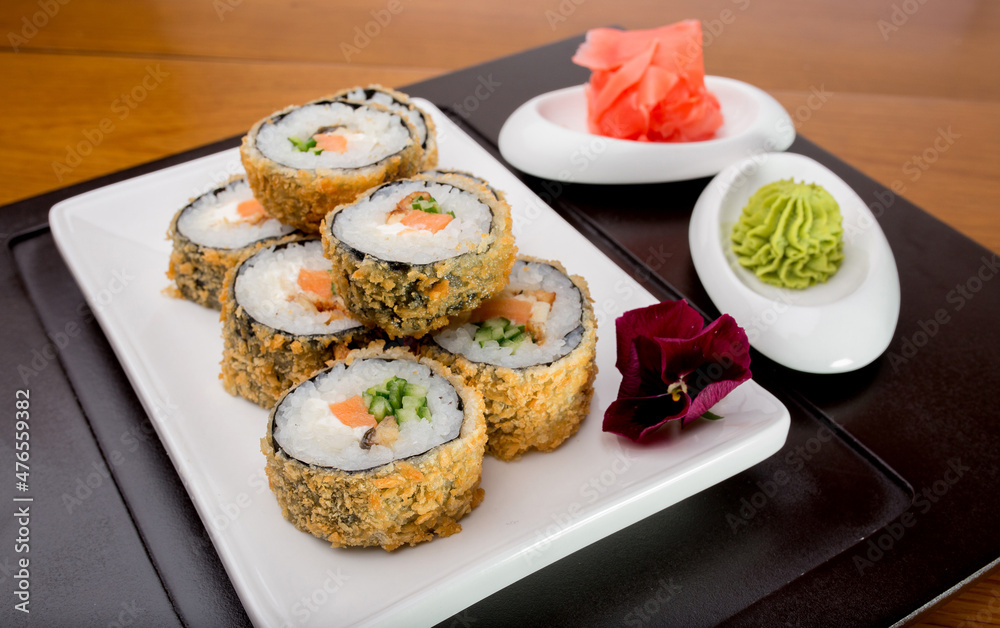 Sushi rolls Japanese delicacies. Japanese traditional rice and fish dishes. Beautiful serving food on a light background with copy space. A set of delicious goodies.
