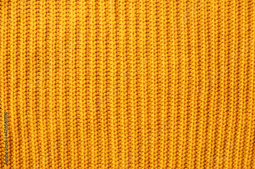 Orange warm sweater knitted striped minimalistic background.