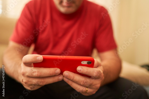 hands of a man using smartphone