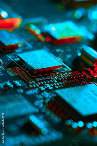 Electronic circuit board with electronic components such as chips close up. Blurry background.