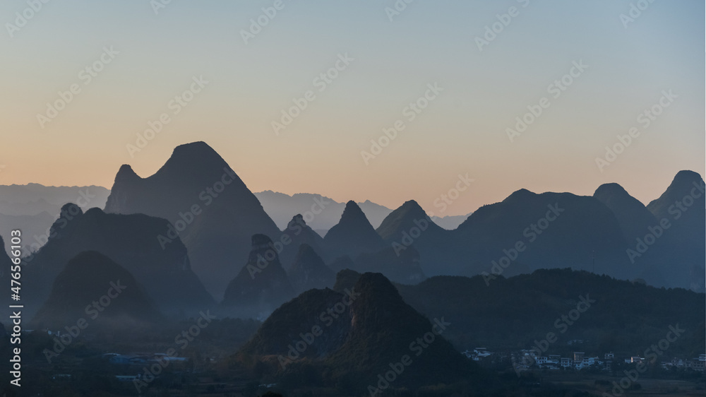 	
The sunset silhouette of Guilin landscape in Guangxi, China is like Chinese landscape painting in the style of ink painting	
