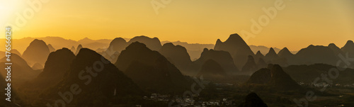 The wide and wide picture, the sunrise silhouette of Guilin landscape in Guangxi, China is like Chinese landscape painting in the style of ink painting	