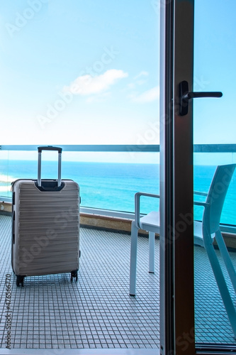 Beige Suitcase on balcony ocean view in luxury beach hotel in  tropical country .Copy space © vasanty