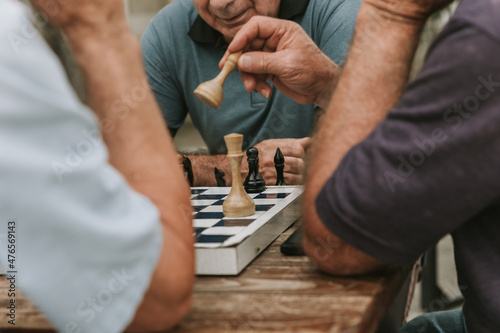 two men playing chess outdoor park in summer 