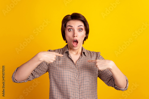 Photo of young woman amazed shock omg wow indicate fingers herself astonished isolated over yellow color background