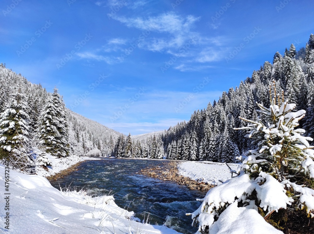 beautiful mountain landscape of carpathians in snow against blue sky. winter in synevyrsky national natural park, tereblya river. ukraine