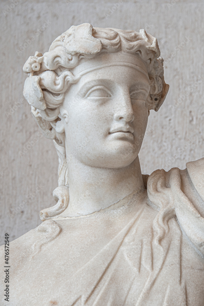 Portrait of an ancient marble statue with a beautiful young Roman Italian or Greek man face of Renaissance Era.