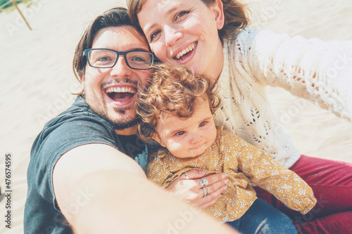 Young family posing together for a selfie in their holidays