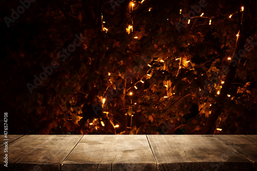 background Image of wooden table in front of abstract blurred lights