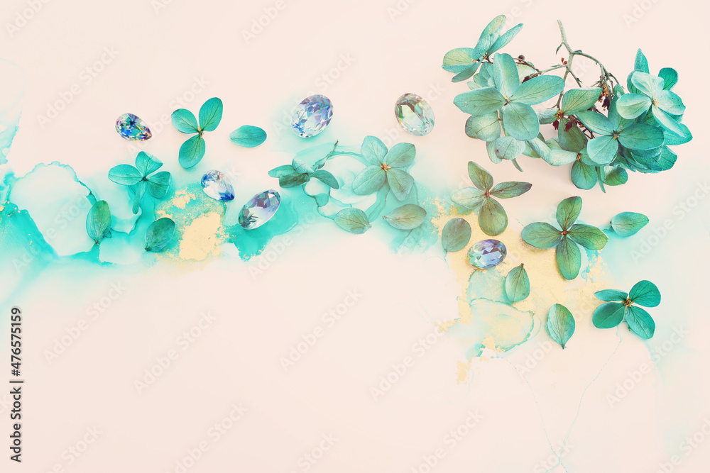 Obraz premium Creative image of emerald and green Hydrangea flowers on artistic ink background. Top view with copy space