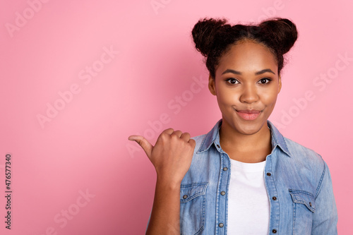 Photo of youth african girl indicate thumb empty space promo offer ad choice suggest isolated over pink color background